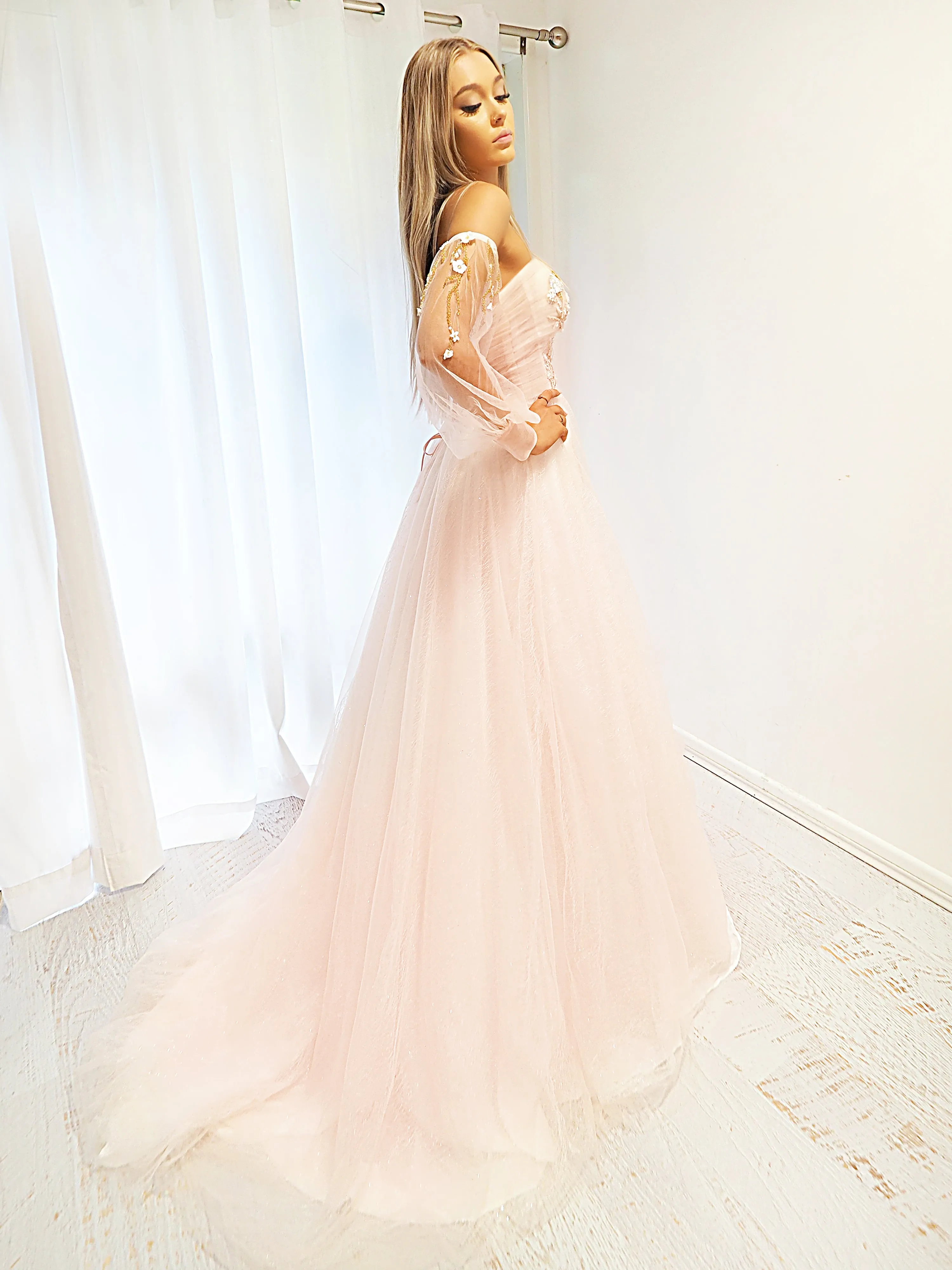 Pastel pink accent straight neck line with a pastel pink flowy skirt and long sleeves.